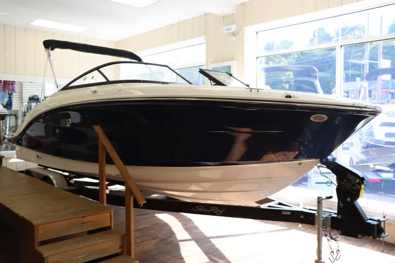 Slide: The Image of 2025 Sea Ray 210SPX boat displayed indoors on a trailer. - 5