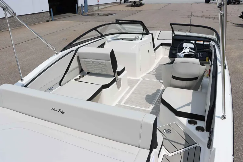Slide: The Image of 2025 Sea Ray 210SPX boat interior with modern seating and steering console. - 9