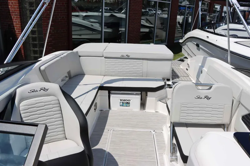 Slide: The Image of 2024 Sea Ray 230SPX boat interior with white seating and Igloo cooler. - 10