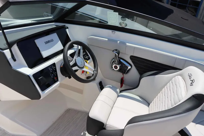 Slide: The Image of 2024 Sea Ray 230SPX boat cockpit with steering wheel and control panel. - 11