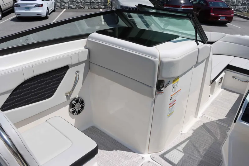 Slide: The Image of Interior of 2024 Sea Ray 230SPX boat, featuring white seating and modern design. - 12