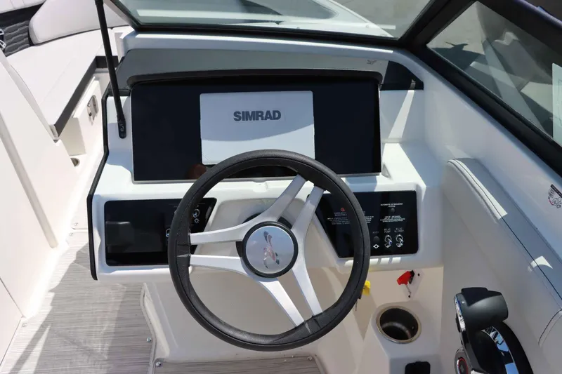 Slide: The Image of 2024 Sea Ray 230SPX boat dashboard with Simrad display and steering wheel. - 14