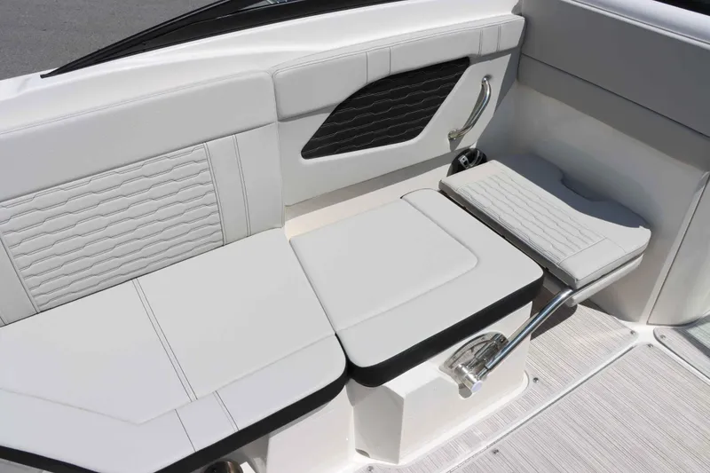 Slide: The Image of 2024 Sea Ray 230SPX boat interior seating with white upholstery and modern design. - 15