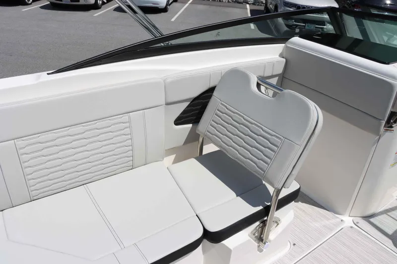 Slide: The Image of 2024 Sea Ray 230SPX boat interior with white cushioned seating. - 16