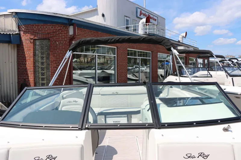 Slide: The Image of 2024 Sea Ray 230SPX boat displayed at a marina dealership. - 18