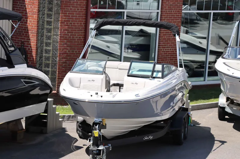 Slide: The Image of 2024 Sea Ray 230SPX boat on display outside a dealership. - 4