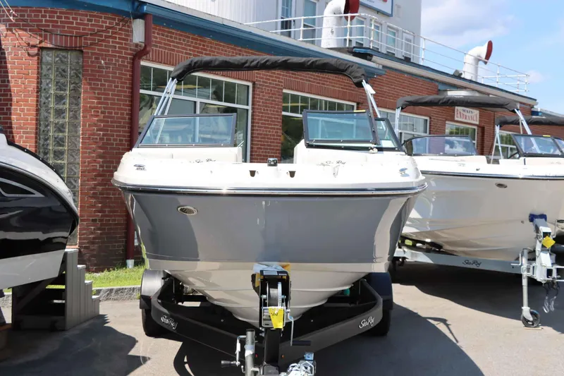 Slide: The Image of 2024 Sea Ray 230SPX boat displayed outside a brick building. - 5