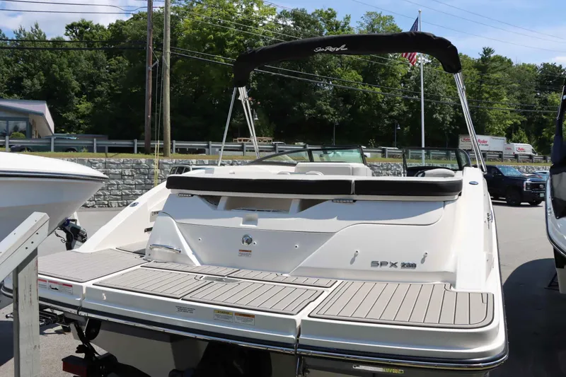 Slide: The Image of 2024 Sea Ray 230SPX boat with swim platform and black canopy. - 6