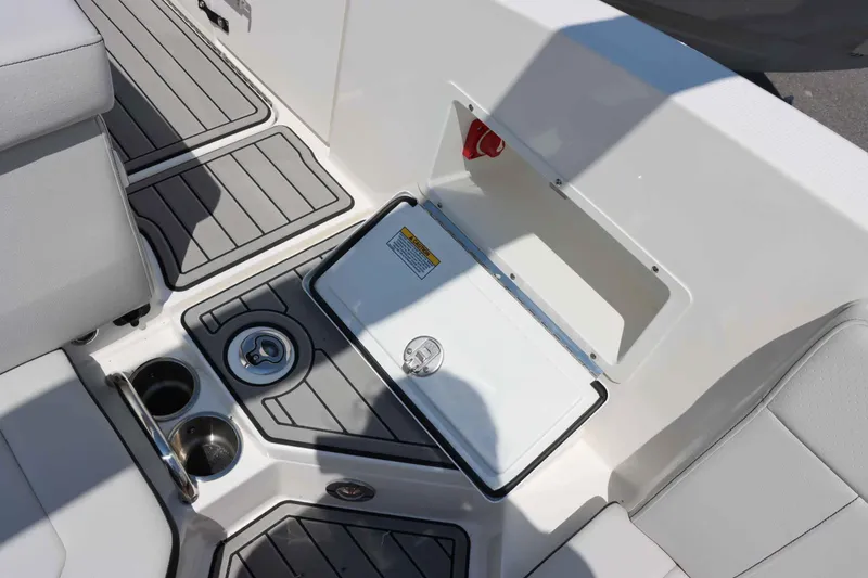 Slide: The Image of 2024 Sea Ray 230SPX boat interior with storage compartment and cup holders. - 8