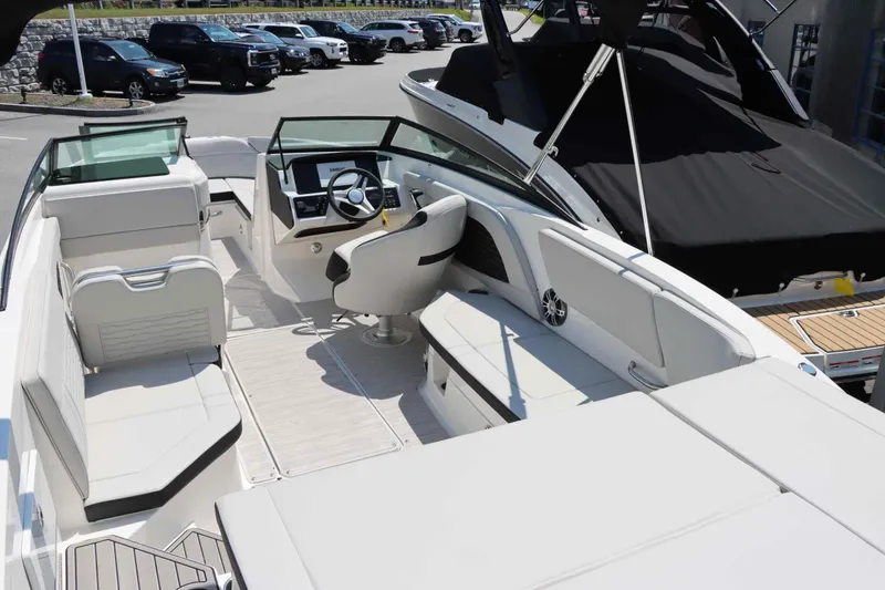 Slide: The Image of 2024 Sea Ray 230SPX boat interior with modern seating and steering console. - 9