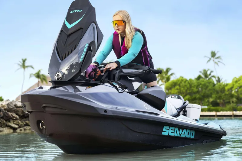 Slide: The Image of 2024 Sea-Doo GTR 230 SS jet ski with rider, tropical background. - 3
