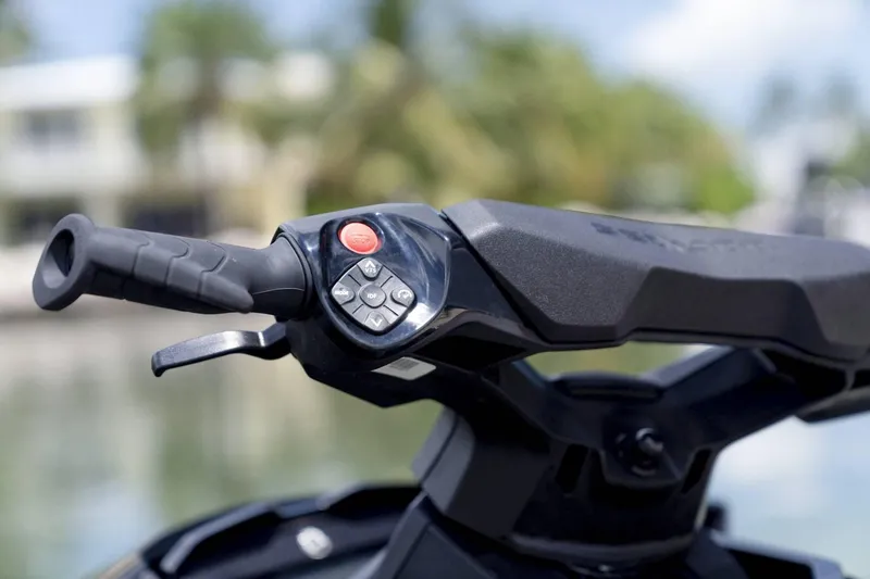 Slide: The Image of Close-up of 2024 Sea-Doo GTX 230 handlebar controls, featuring ergonomic design and buttons. - 5