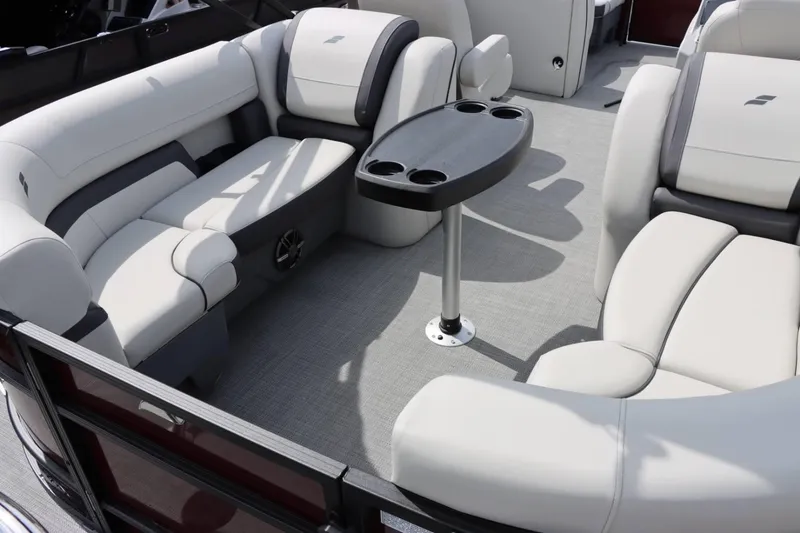 Slide: The Image of 2024 Starcraft EXS 3 boat interior with plush seating and a central table. - 13
