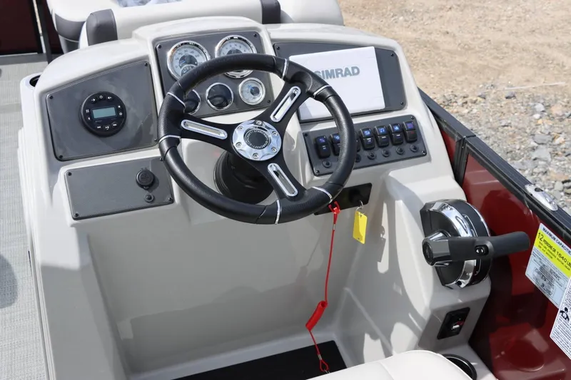 Slide: The Image of 2024 Starcraft EXS 3 boat dashboard with steering wheel, gauges, and control panel. - 16