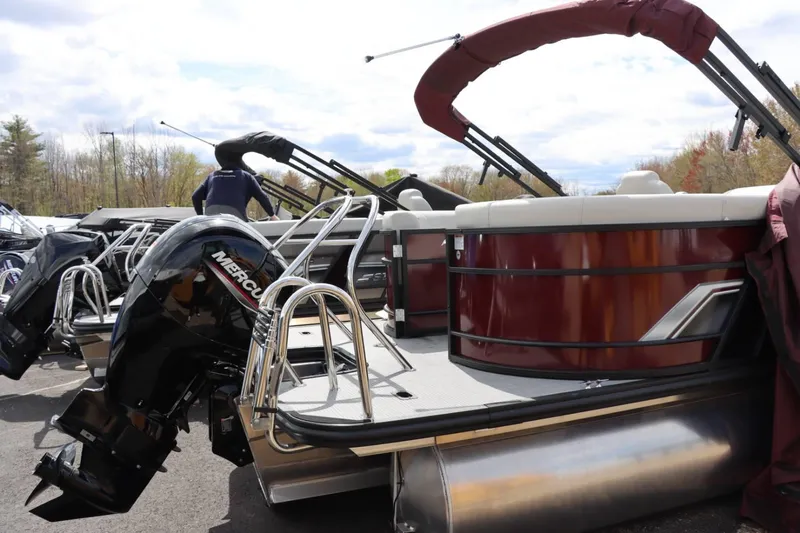 Slide: The Image of 2024 Starcraft EXS 3 pontoon boat with Mercury outboard motor. - 4