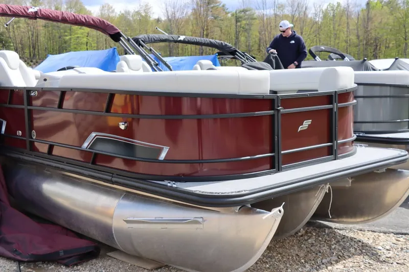 Slide: The Image of 2024 Starcraft EXS 3 pontoon boat with maroon exterior and white seating. - 6