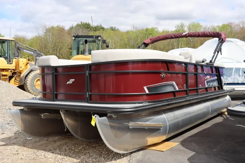 Slide: The Image of 2024 Starcraft EXS 3 pontoon boat in a yard with construction equipment. - 7