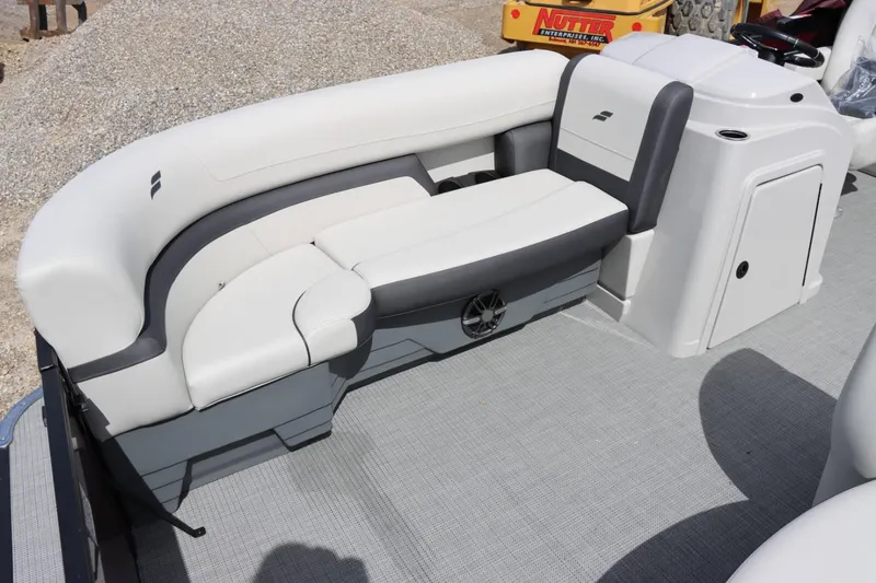 Slide: The Image of 2024 Starcraft EXS 3 pontoon boat interior with cushioned seating and control console. - 9
