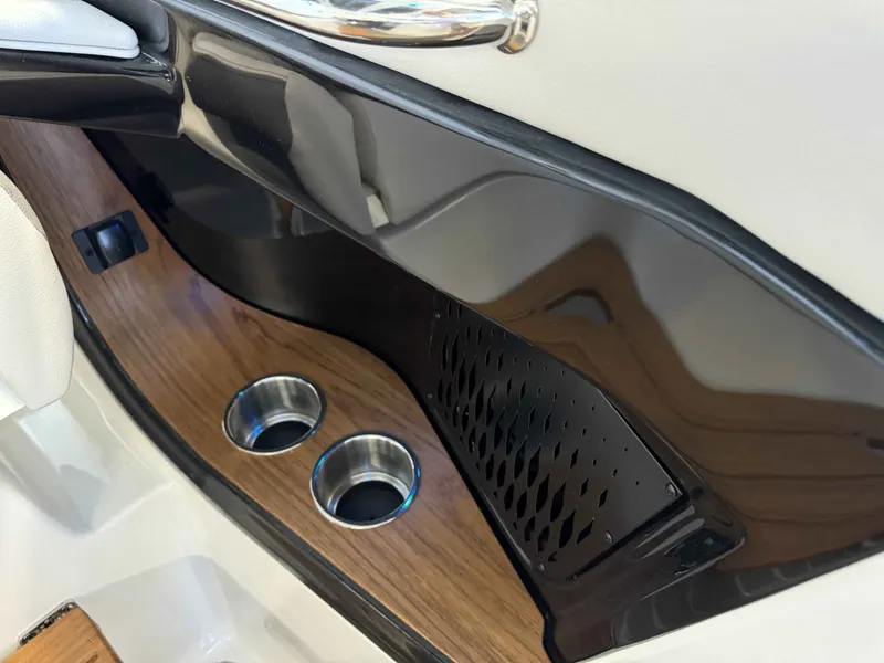 Slide: The Image of 2024 Sea Ray 370 Sundancer interior detail with wood finish and cup holders. - 10