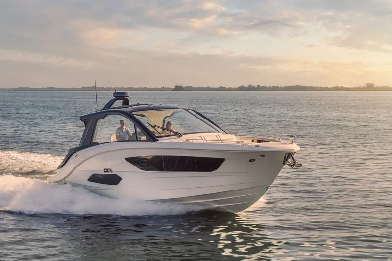 Slide: The Image of 2024 Sea Ray 370 Sundancer cruising on open water at sunset. - 14