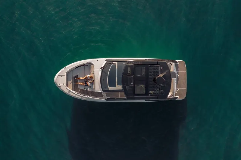 Slide: The Image of Aerial view of 2024 Sea Ray 370 Sundancer yacht on calm water. - 19