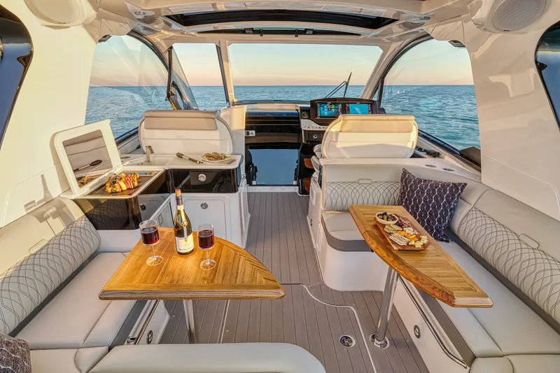 Slide: The Image of Luxurious 2024 Sea Ray 370 Sundancer yacht interior with elegant seating and dining setup. - 29