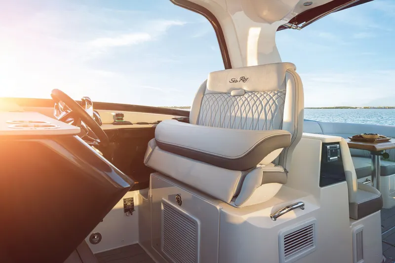 Slide: The Image of 2024 Sea Ray 370 Sundancer helm with luxurious seating and ocean view. - 33