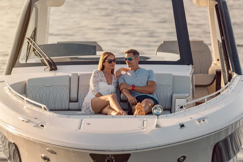 Slide: The Image of Couple relaxing on 2024 Sea Ray 370 Sundancer yacht, enjoying a sunny day on the water. - 34
