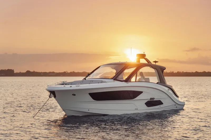 Slide: The Image of 2024 Sea Ray 370 Sundancer yacht at sunset on calm waters. - 37