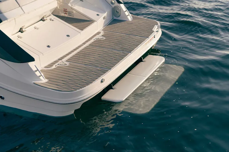 Slide: The Image of 2024 Sea Ray 370 Sundancer swim platform on calm water. - 38
