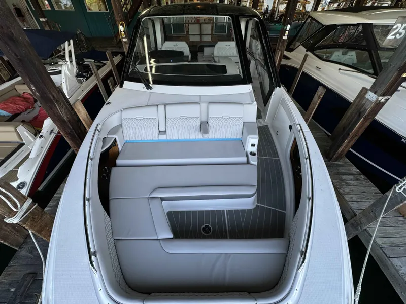 Slide: The Image of 2024 Sea Ray 370 Sundancer boat interior with sleek seating and modern design. - 5