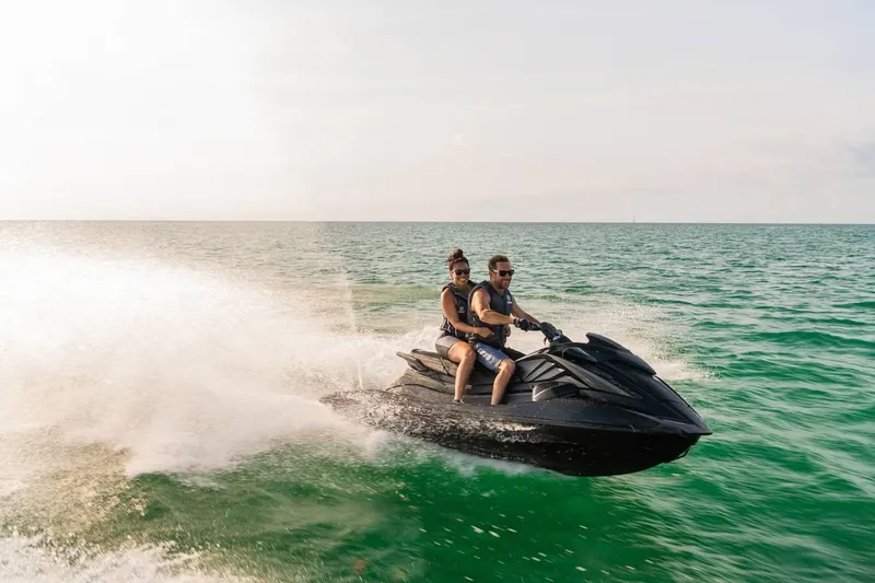 Slide: The Image of Two people riding a 2024 Waverunner GP SVHO A on the ocean. - 3