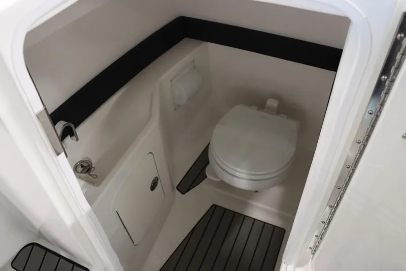 Slide: The Image of 2024 Sea Ray 280SLX boat interior bathroom with toilet and storage compartment. - 10