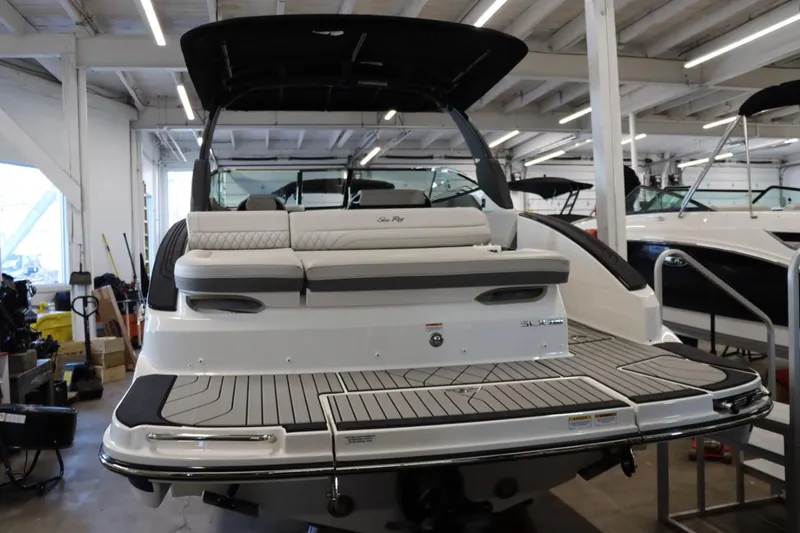 Slide: The Image of 2024 Sea Ray 280SLX luxury boat in showroom, rear view with seating and swim platform. - 3
