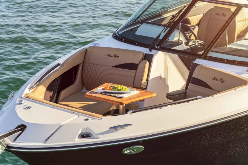 Slide: The Image of 2024 Sea Ray 260SXS boat interior with luxury seating and a snack table. - 10