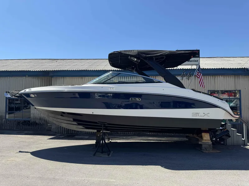 Slide: The Image of 2024 Sea Ray 260SXS boat on display outside a marine dealership. - 3
