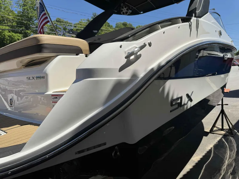 Slide: The Image of 2024 Sea Ray 260SXS boat, rear view with SLX branding and American flag. - 4