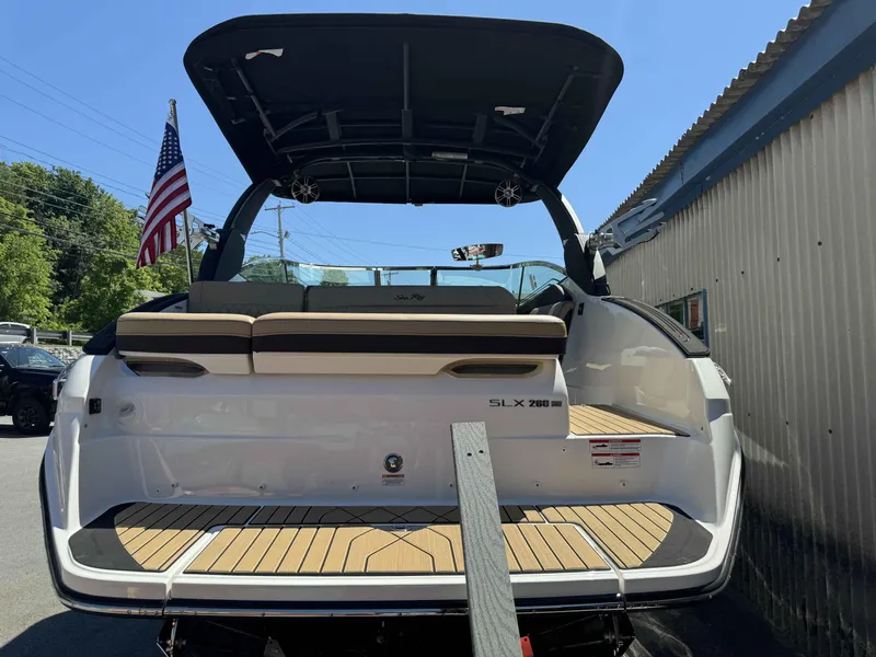 Slide: The Image of 2024 Sea Ray 260SXS boat rear view with American flag and teak deck. - 6