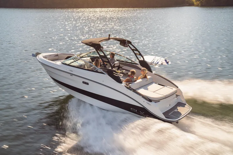 Slide: The Image of 2024 Sea Ray 260SXS boat cruising on a sunny lake with passengers. - 9