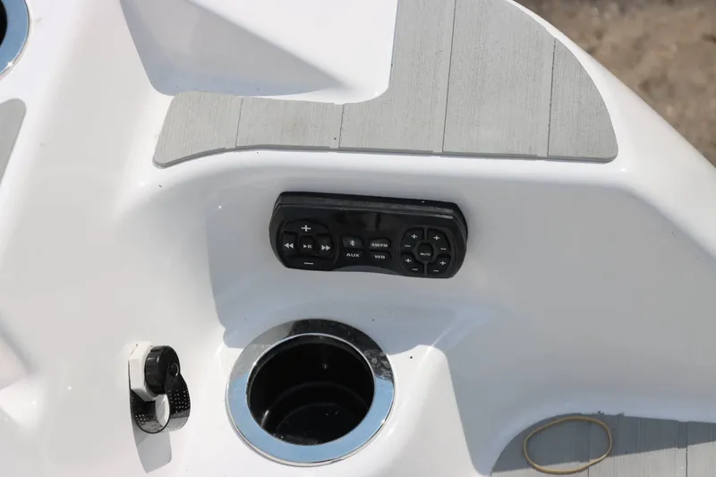 Slide: The Image of 2024 Yamaha AR250 boat control panel with cup holder and audio controls. - 12