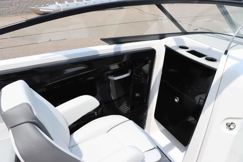 Slide: The Image of 2024 Yamaha Boats AR250 interior with white seating and black console. - 18
