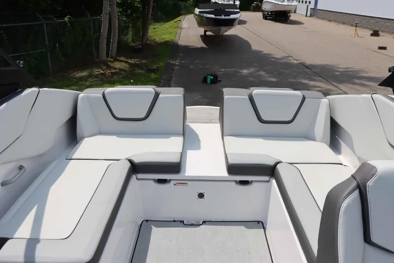 Slide: The Image of 2024 Yamaha AR250 boat interior with sleek white seating and modern design. - 19