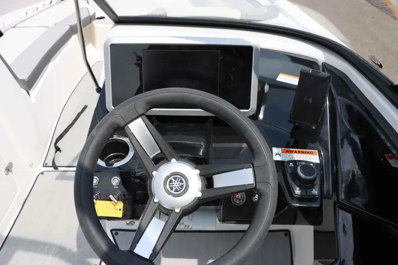 Slide: The Image of 2024 Yamaha AR250 boat dashboard with steering wheel and control panel. - 21