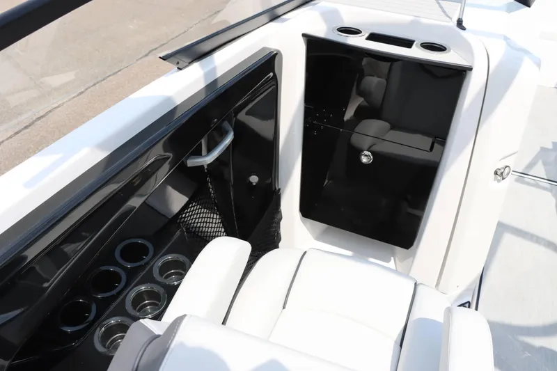 Slide: The Image of 2024 Yamaha AR250 boat interior with cup holders and storage compartment. - 22