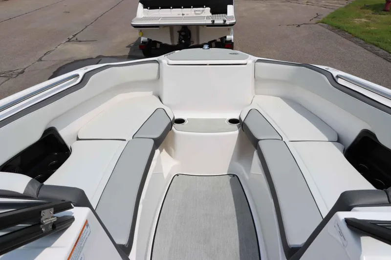 Slide: The Image of 2024 Yamaha AR250 boat interior with spacious seating and cup holders. - 24