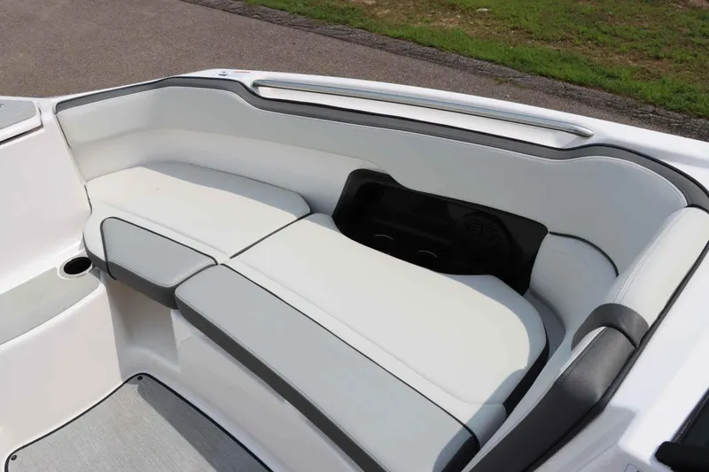 Slide: The Image of 2024 Yamaha AR250 boat interior with white cushioned seating and cup holders. - 25