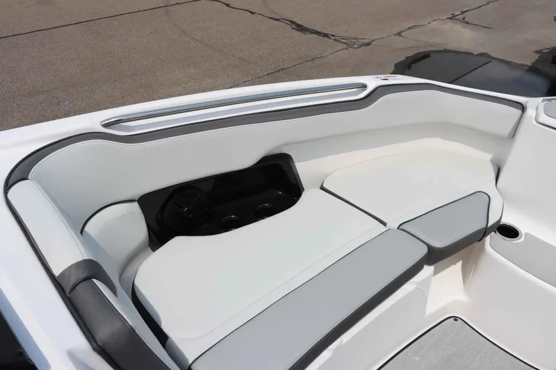 Slide: The Image of 2024 Yamaha AR250 boat interior seating with sleek white and gray design. - 26