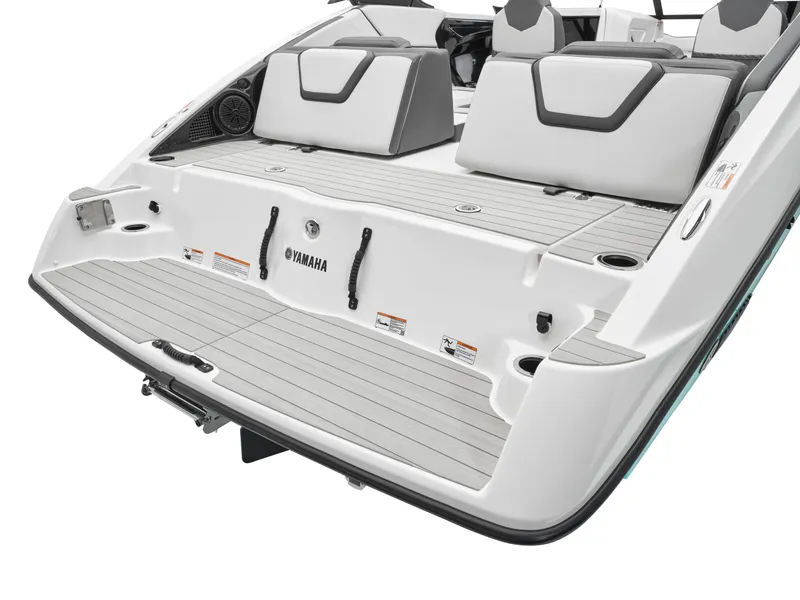 Slide: The Image of 2024 Yamaha Boats AR250 rear deck with seating and storage. - 32