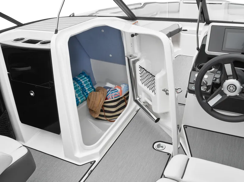 Slide: The Image of 2024 Yamaha Boats AR250 interior storage compartment with beach gear. - 34