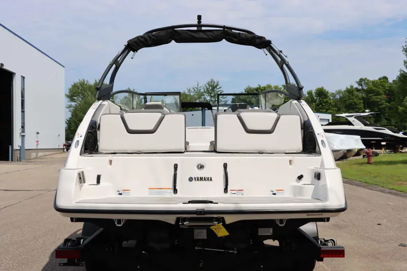 Slide: The Image of 2024 Yamaha AR250 boat rear view, showcasing sleek design and spacious seating. - 8